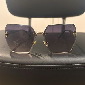 Signature arm sunglasses. Notice the details above on each lens.